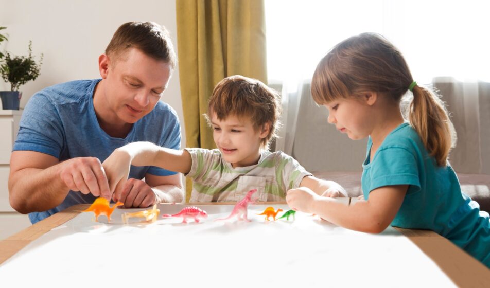 Adult children playing dino