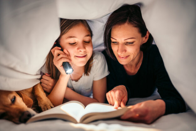 Foster mum reading to her foster daughter